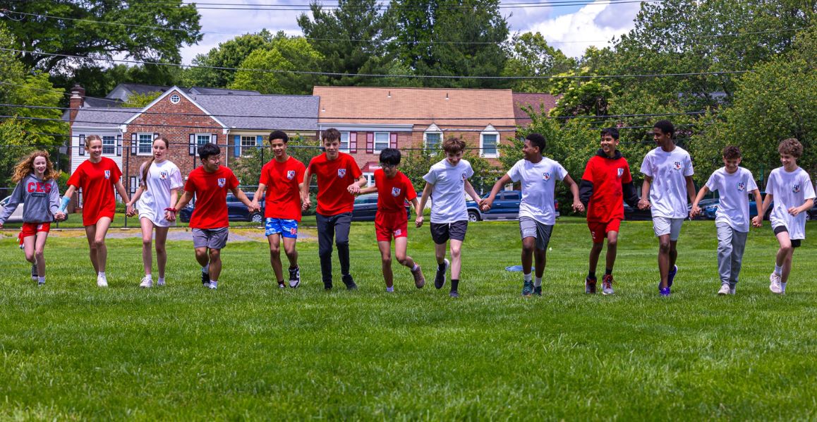 Christ Episcopal School students holding hands and running together on Field Day